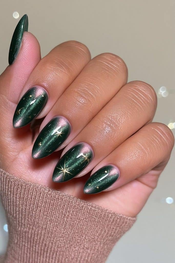 Forest-green cat-eye Christmas tree nails with velvet shimmer and tiny gold stars