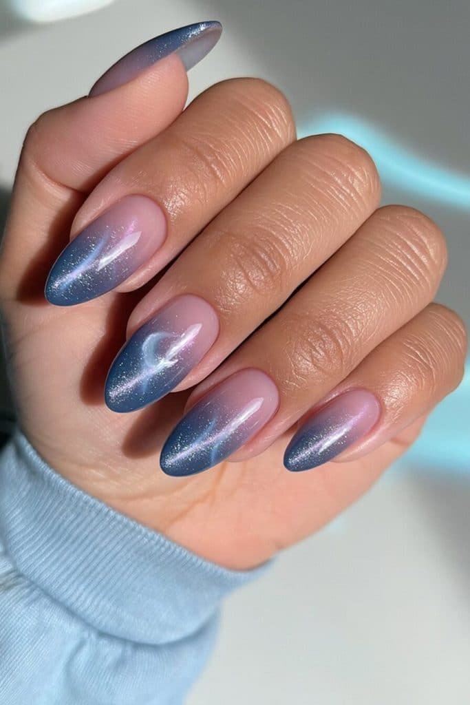 Glass jelly dark blue cat-eye nails with translucent sapphire depth and luminous magnetic ribbons