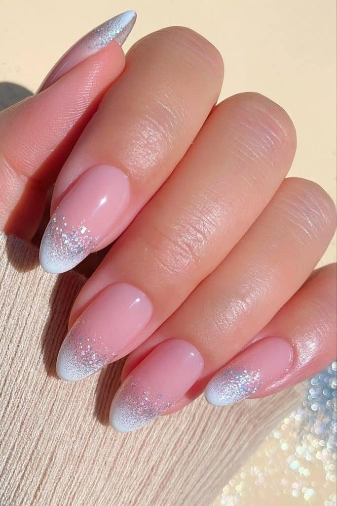 White French tip nails dipped in fine silver glitter with a soft sparkling fade
