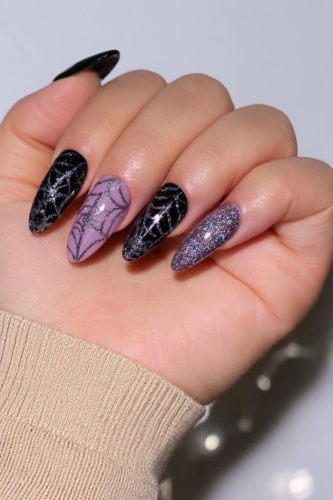 Glittery black spider web nails with fine silver web lines and sparkling charcoal shimmer