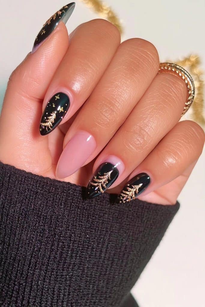 Glossy black almond nails with elegant gold Christmas tree designs and tiny stars
