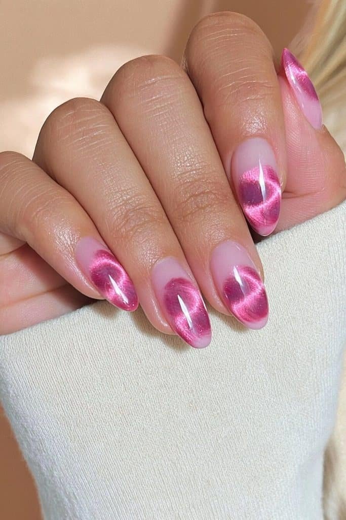 Hot pink cat-eye nails with intense fuchsia magnetic bands and a bold glossy finish