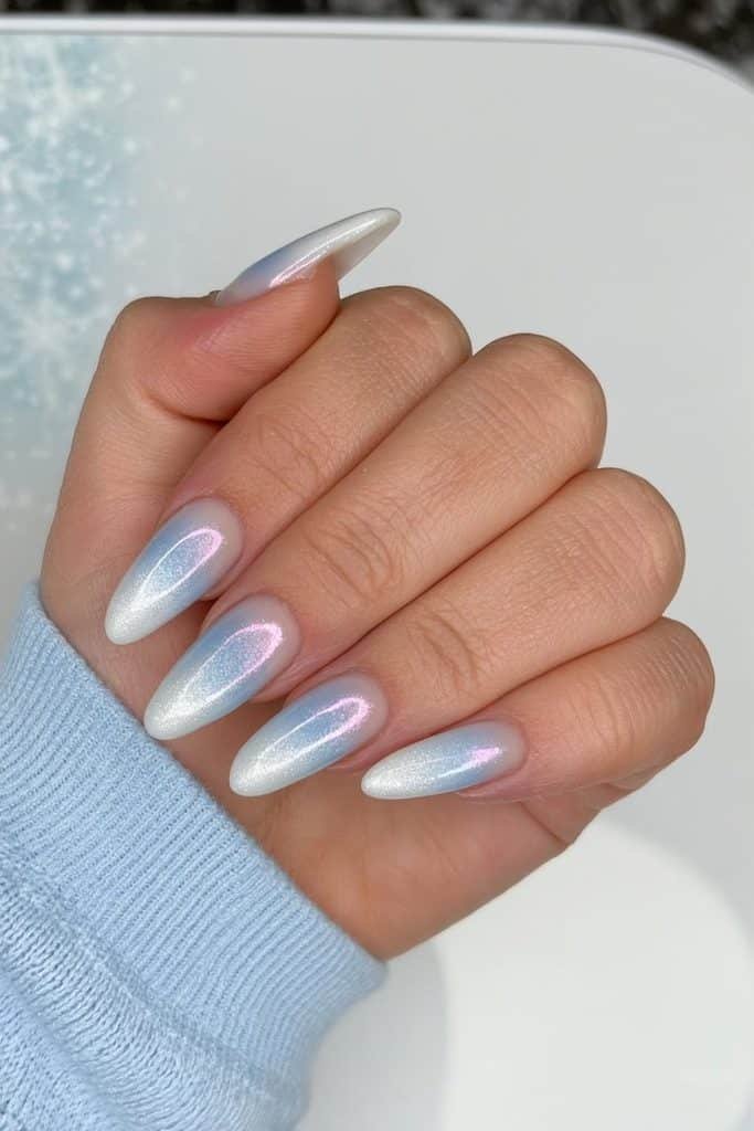 Icy blue ombré ski nails fading from frosty sky blue to snowy white