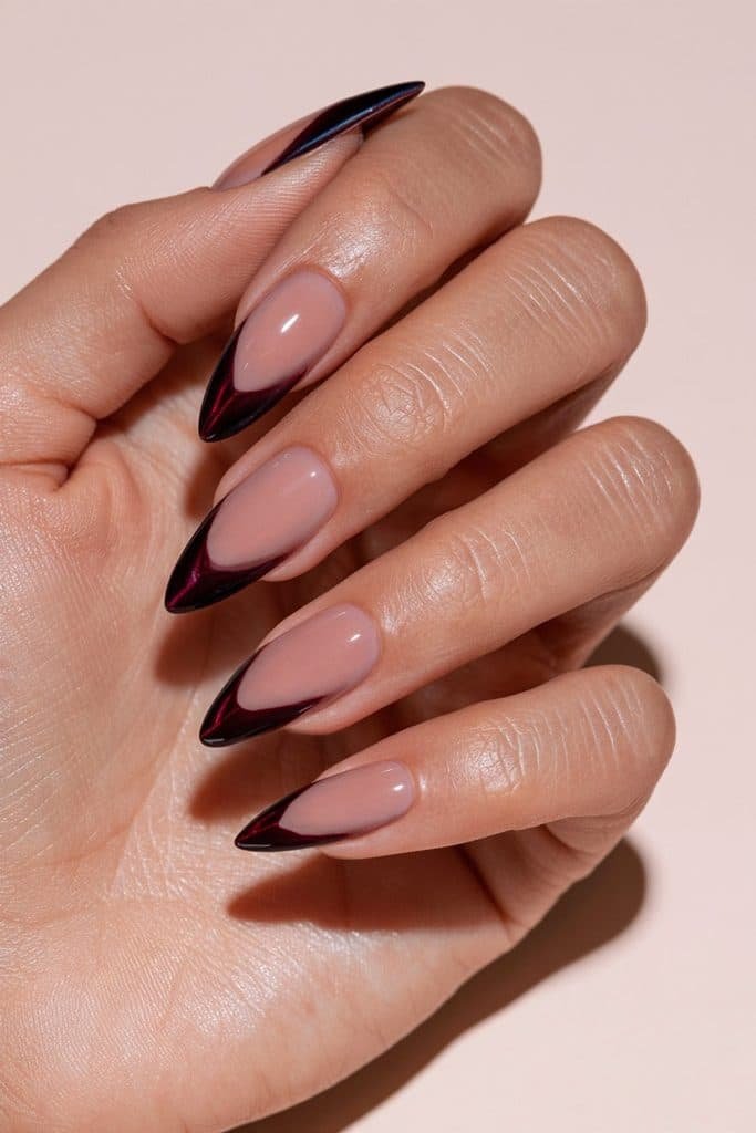 Maroon cat eye French tip nails with sheer blush-pink bases and curved burgundy tips featuring ruby magnetic shimmer.