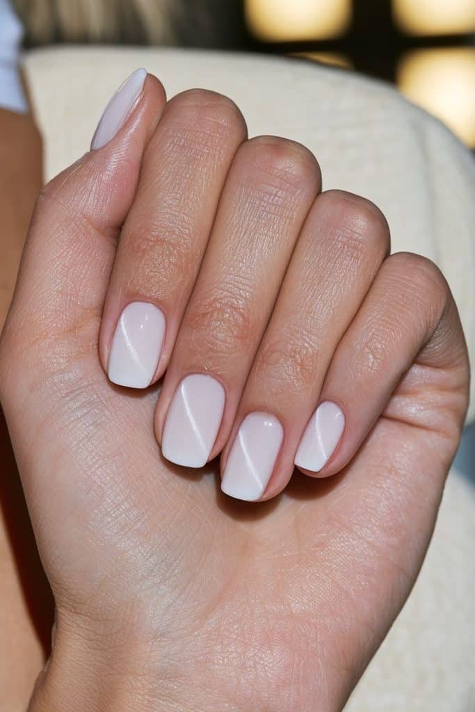 Milky white cat eye nails with luminous magnetic stripes and a glossy finish