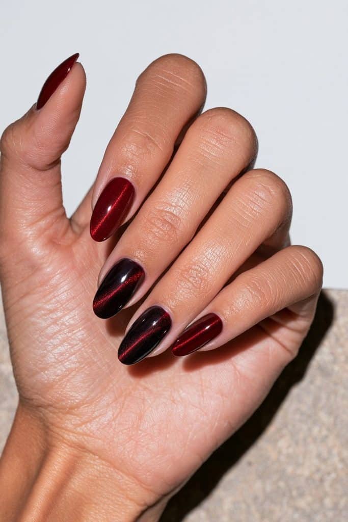 Mix-and-match red cat eye nails in cherry, ruby, burgundy, cranberry, and wine shades with glowing magnetic shimmer.
