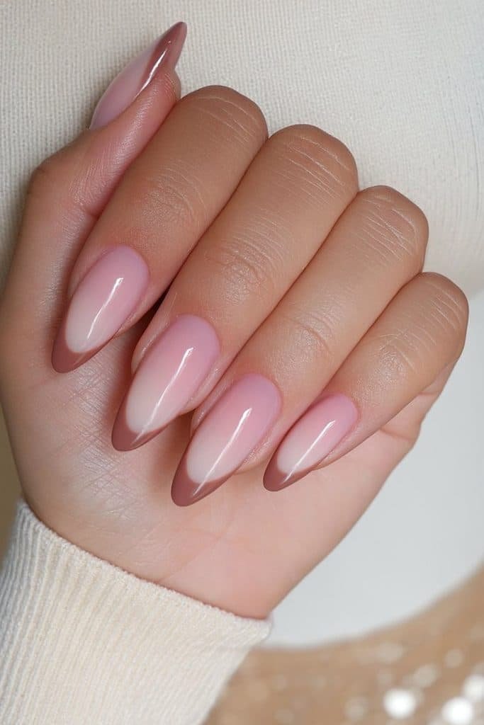 Reverse mocha French nails with coffee-brown cuticle arcs over a sheer neutral base