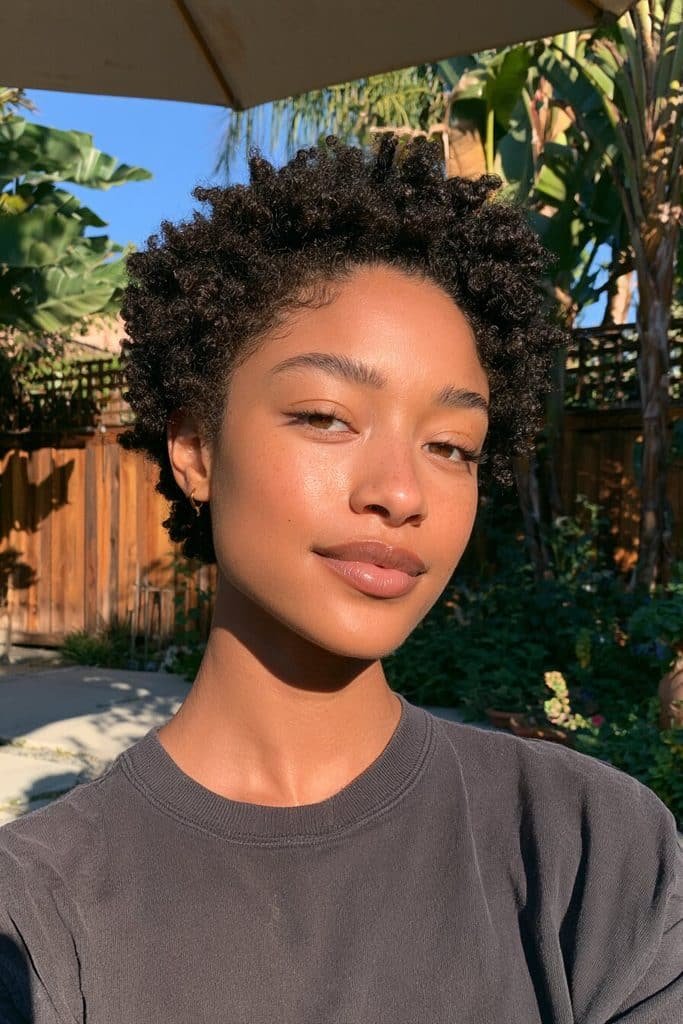 Natural 4C coily pixie cut for Black women with tightly coiled hair, natural shrinkage, and a softly rounded shape.