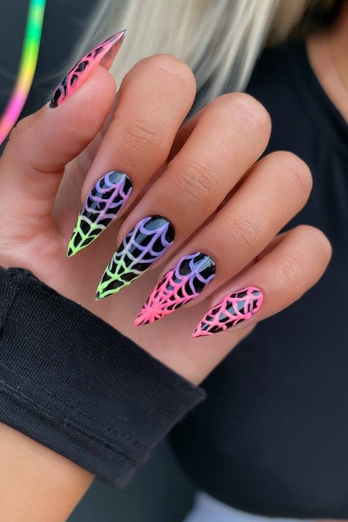 Black spider web nails with vibrant neon-lime, electric-purple, and hot-pink web designs