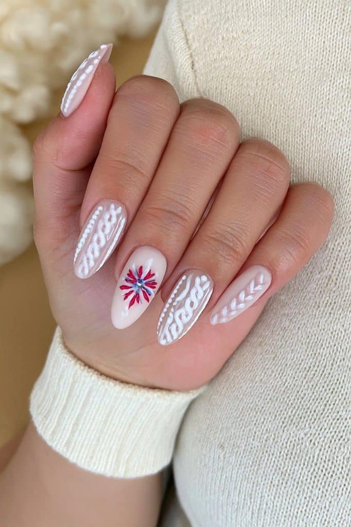 Nordic ski nails with geometric snowflakes, diamonds, and zigzags in cranberry, forest green, and white