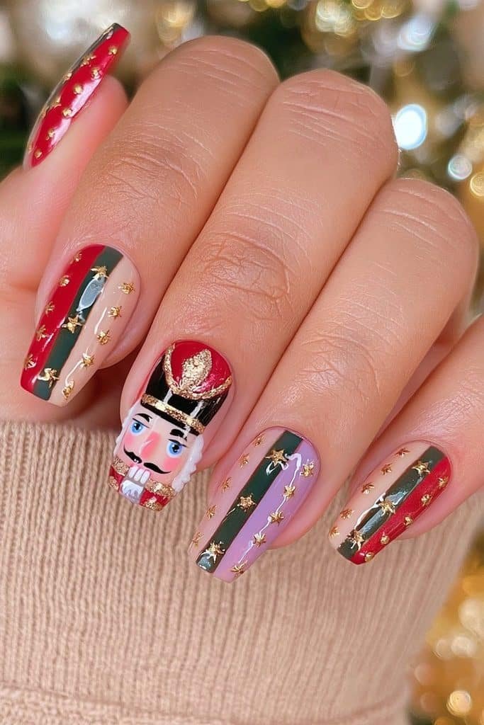 Red, cream, and green nutcracker nails featuring a detailed toy-soldier face accent