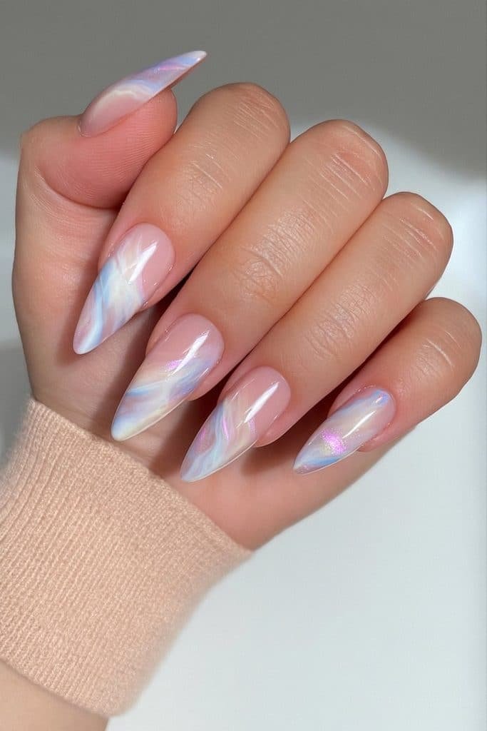 Pale pink and icy blue marble nails with milky swirls and pearlescent accents