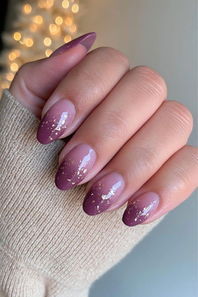 Sugar plum purple nails with delicate gold foil flakes and deep berry undertones