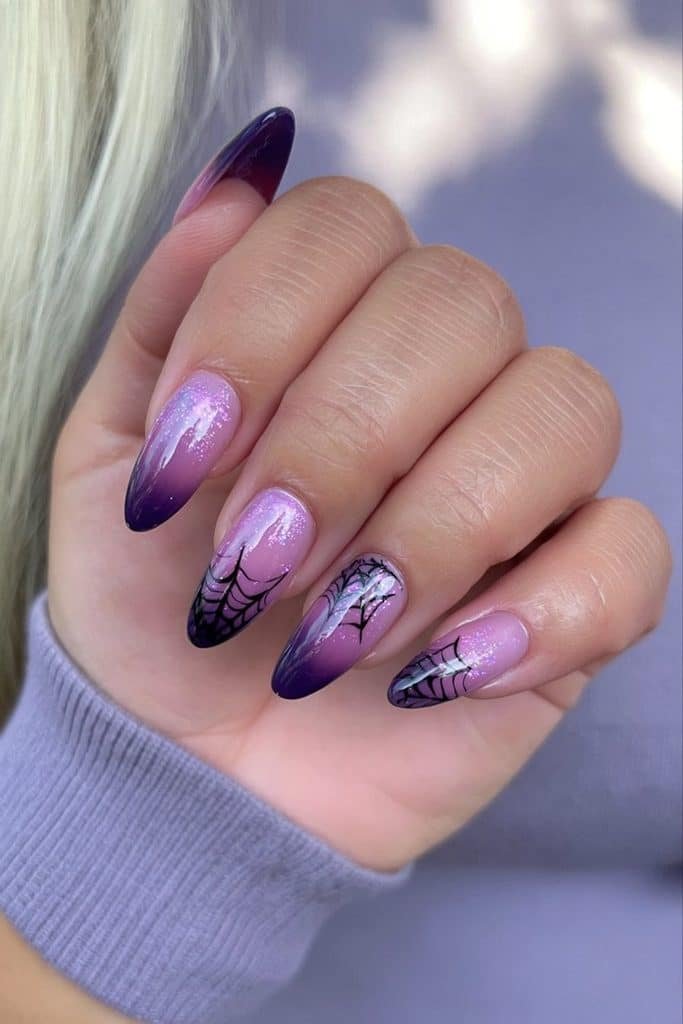 Purple spider web nails with a violet gradient, fine black web artwork, and lilac shimmer