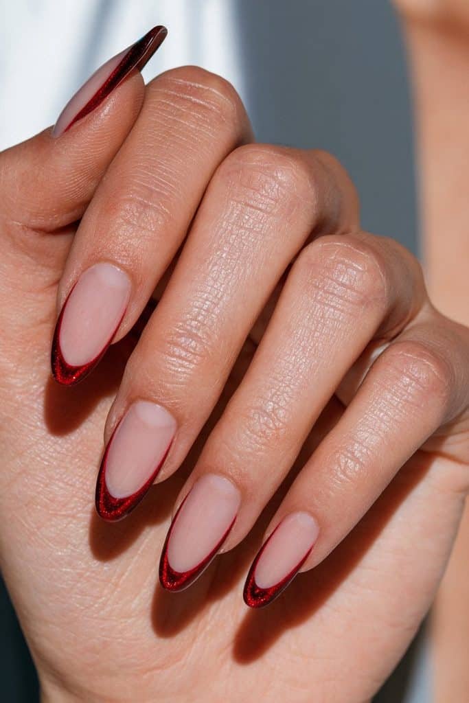 Red cat eye French tip nails with glowing cherry-red magnetic tips and a sheer blush-pink base.