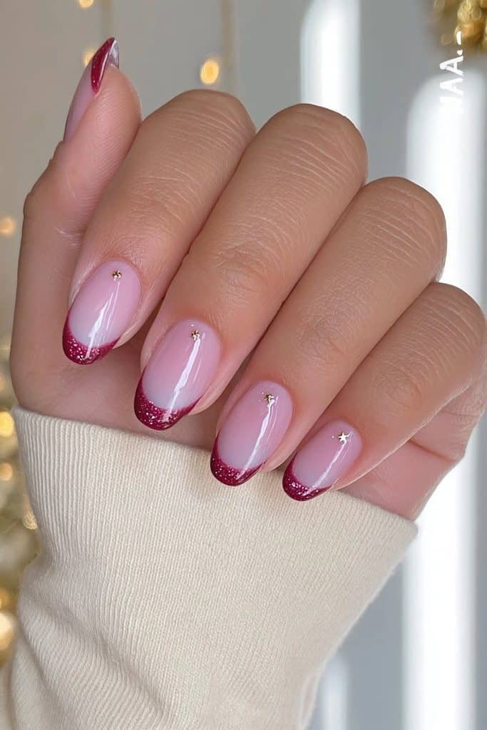 Ruby-red French tip nails with miniature nutcracker soldiers and delicate gold stars
