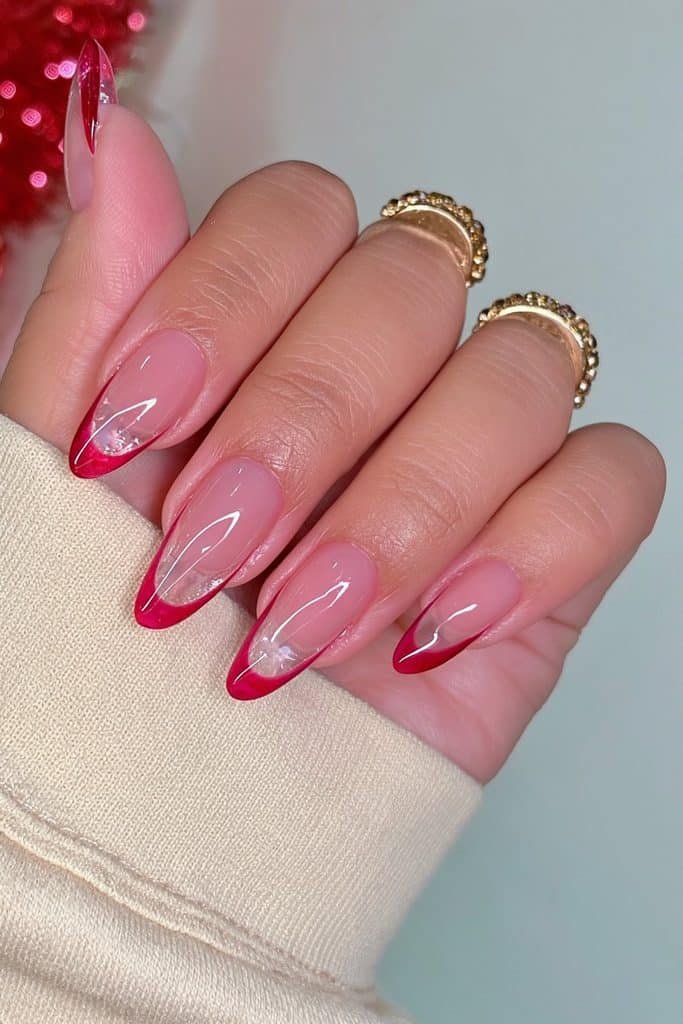 Sheer jelly nails with translucent cherry-red French tips and glossy glass-like finish