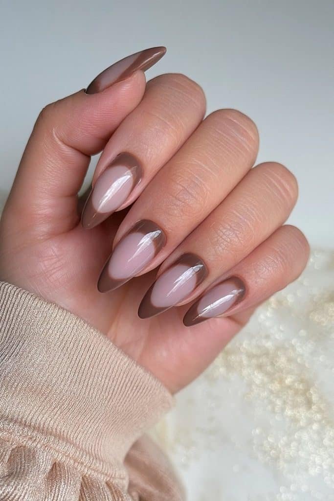 Reverse mocha French nails with coffee-brown cuticle arcs over a sheer neutral base