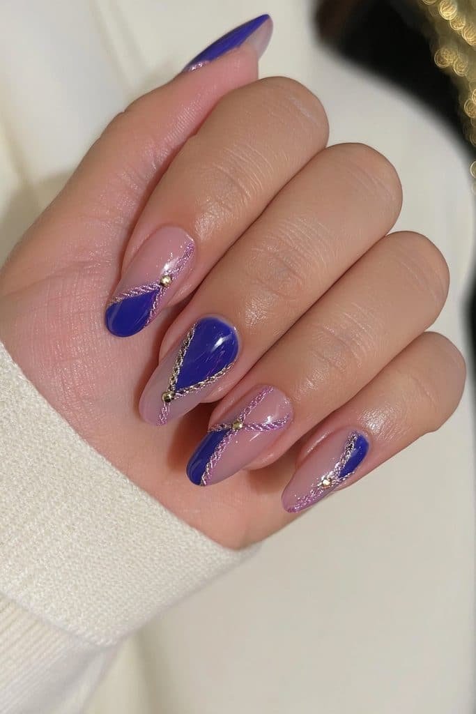 Royal-blue nutcracker uniform nails with golden epaulettes, decorative braids, and crowns