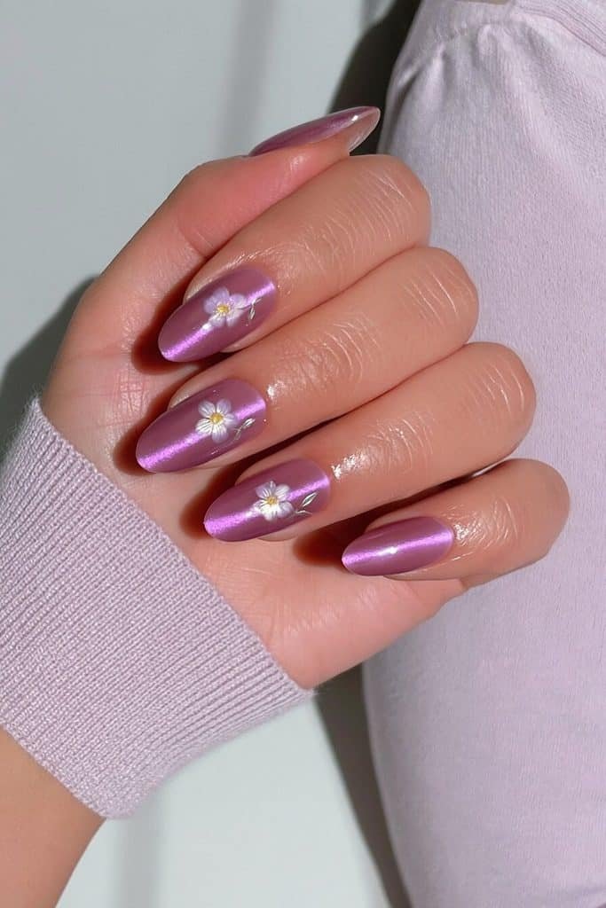 Royal violet cat-eye nails with radiant purple magnetic trails and delicate lavender floral accents