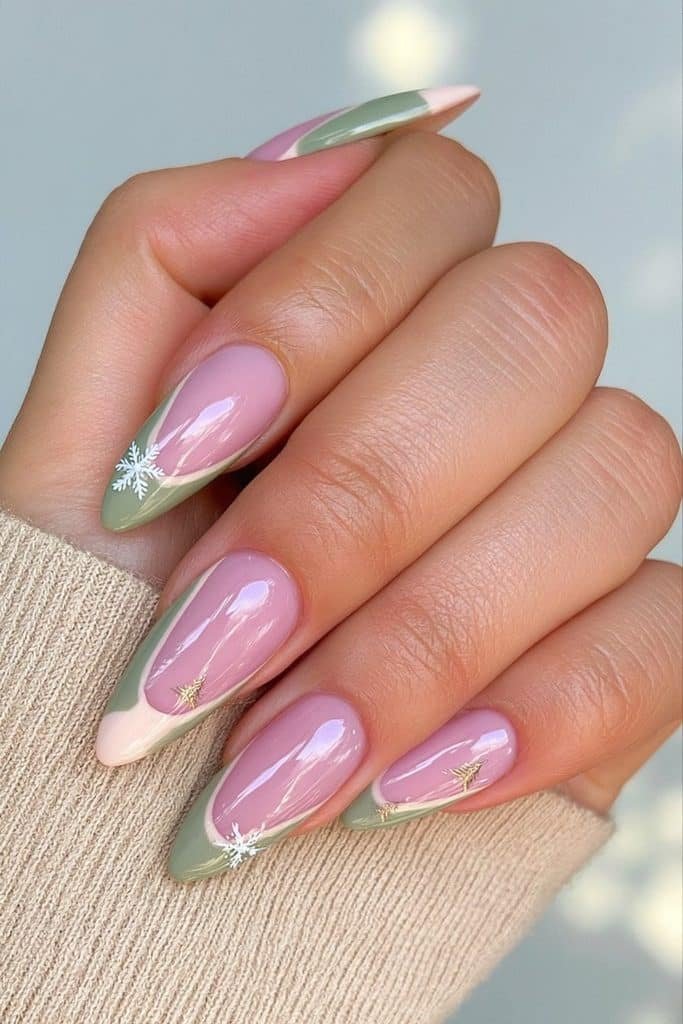 Sage green après-ski nails with ivory snowflakes, tiny pine trees, and champagne accents