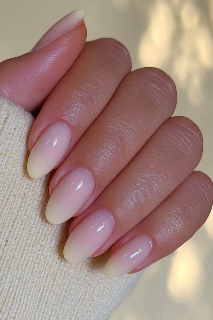 Sheer milky butter yellow nails with translucent vanilla tones and a glossy jelly finish