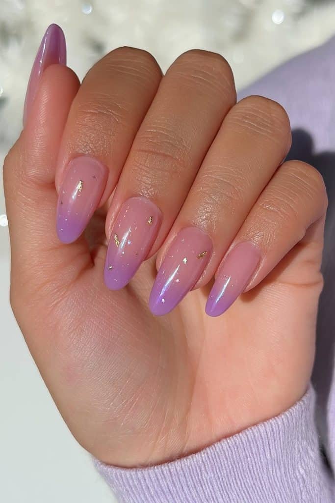 Sheer sugar plum jelly nails in mauve, berry, and lavender with tiny gold ornaments