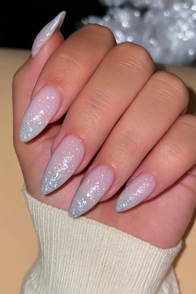 Milky white snowstorm nails with fine silver shimmer and sparkling holographic flecks