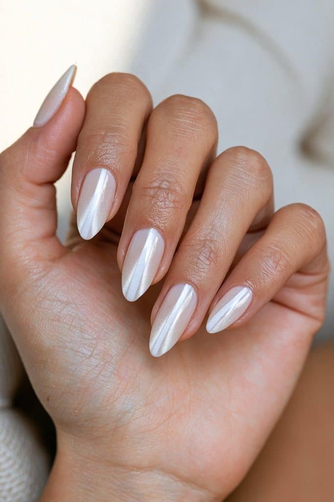 Short almond white cat eye nails with defined magnetic light bands and a glossy finish