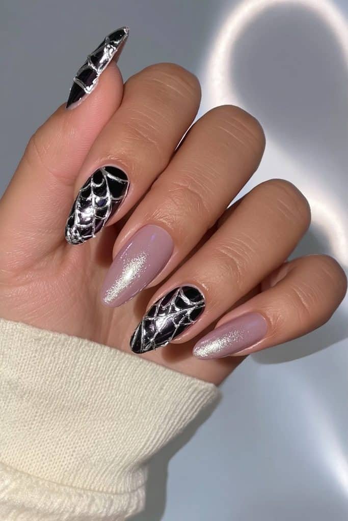 Glossy black spider web nails with raised silver chrome threads and metallic reflections