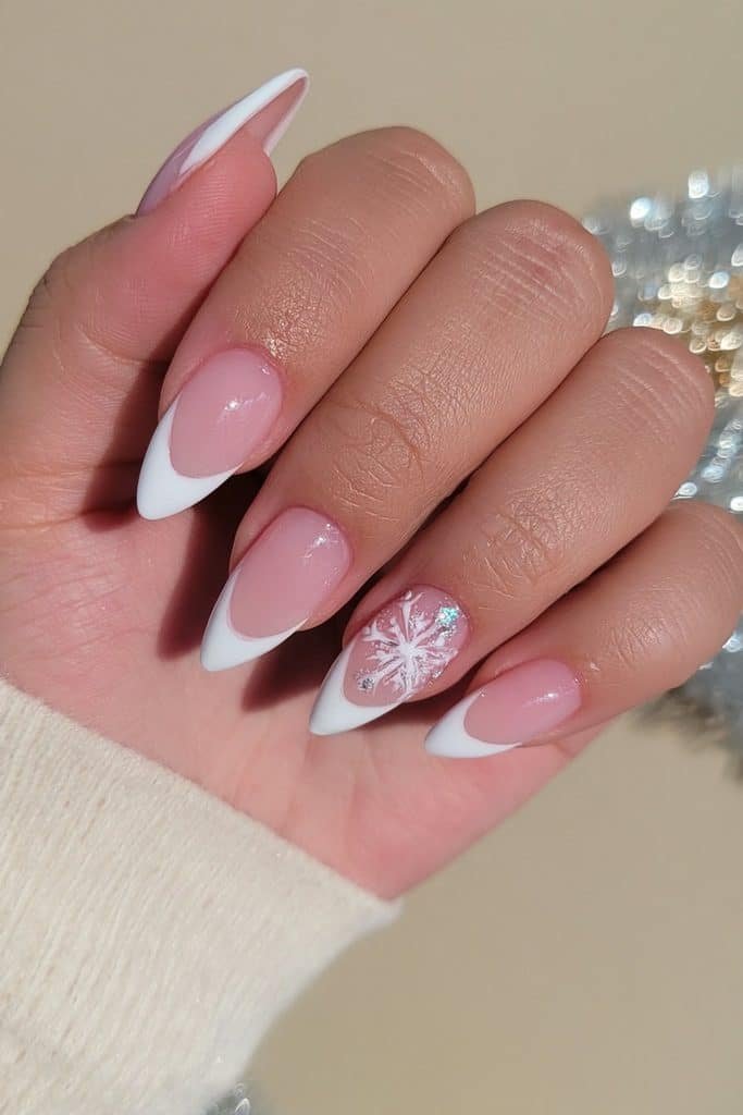 White French tip nails with a delicate hand-painted snowflake and silver accents