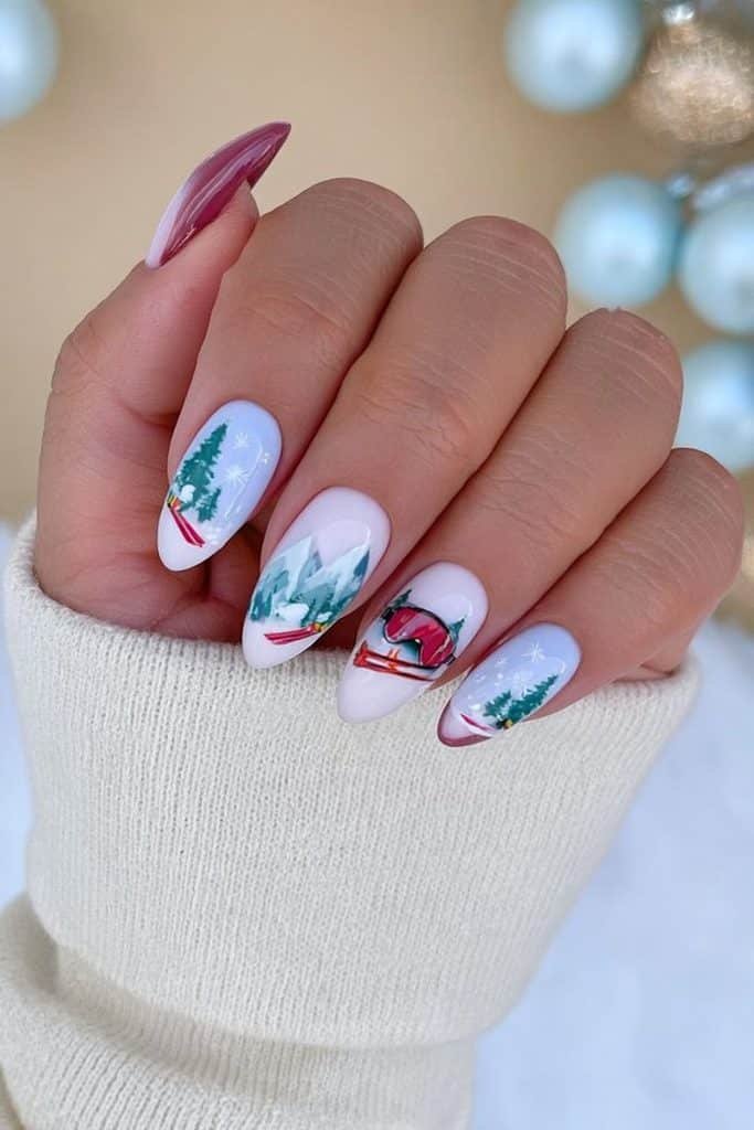 Ski trip nails with tiny ski goggles, miniature skis, snowy mountains, pine trees, and snowflakes