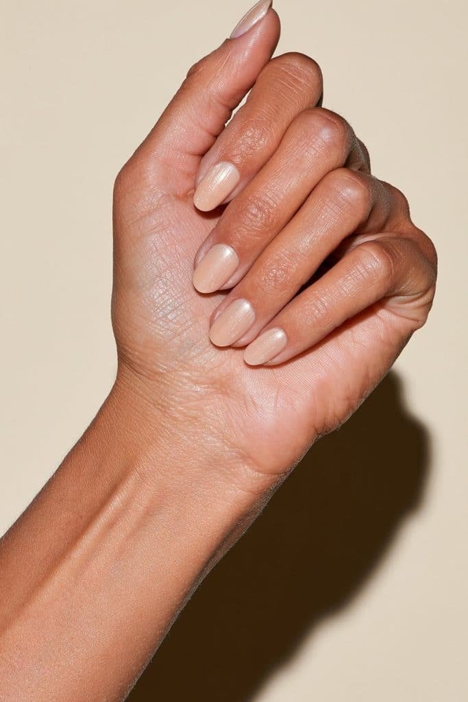 Pale peachy-orange cat eye nails with a subtle, light-catching magnetic glow.
