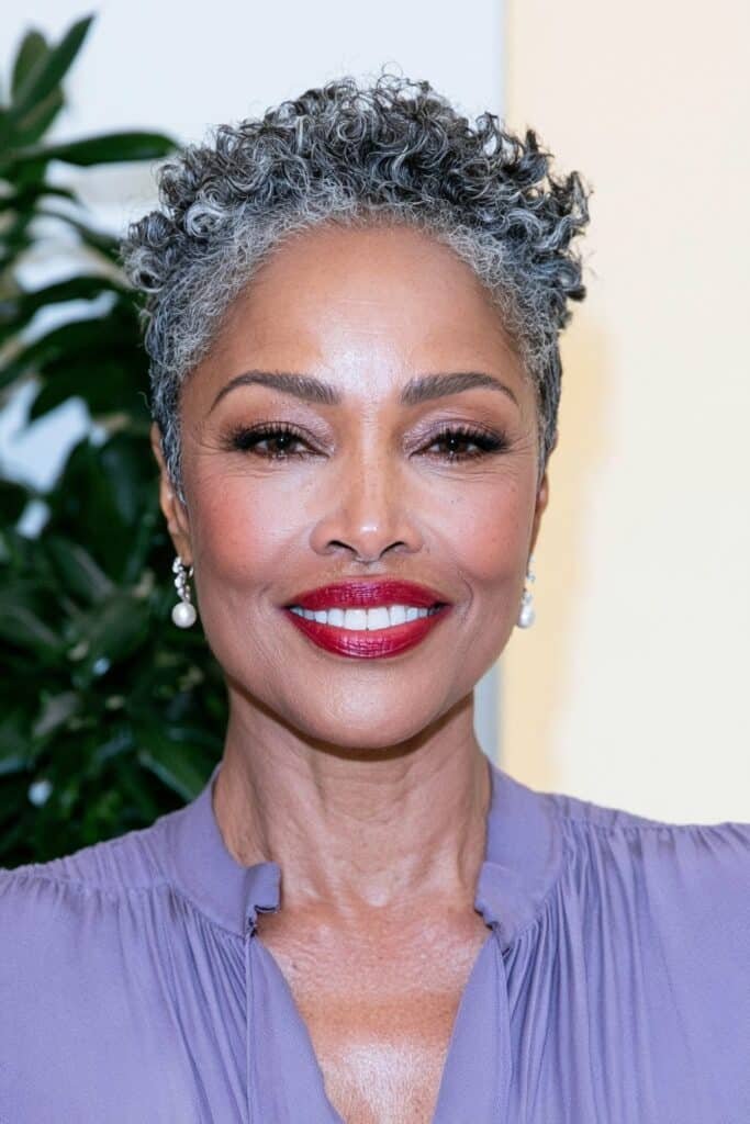 Black woman over 60 with a soft tapered crop haircut, featuring short natural texture, gentle volume, and neatly shaped sides.
