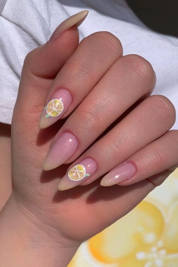 Butter yellow nails with tiny hand-painted lemon slices, delicate white outlines, and fresh green leaves