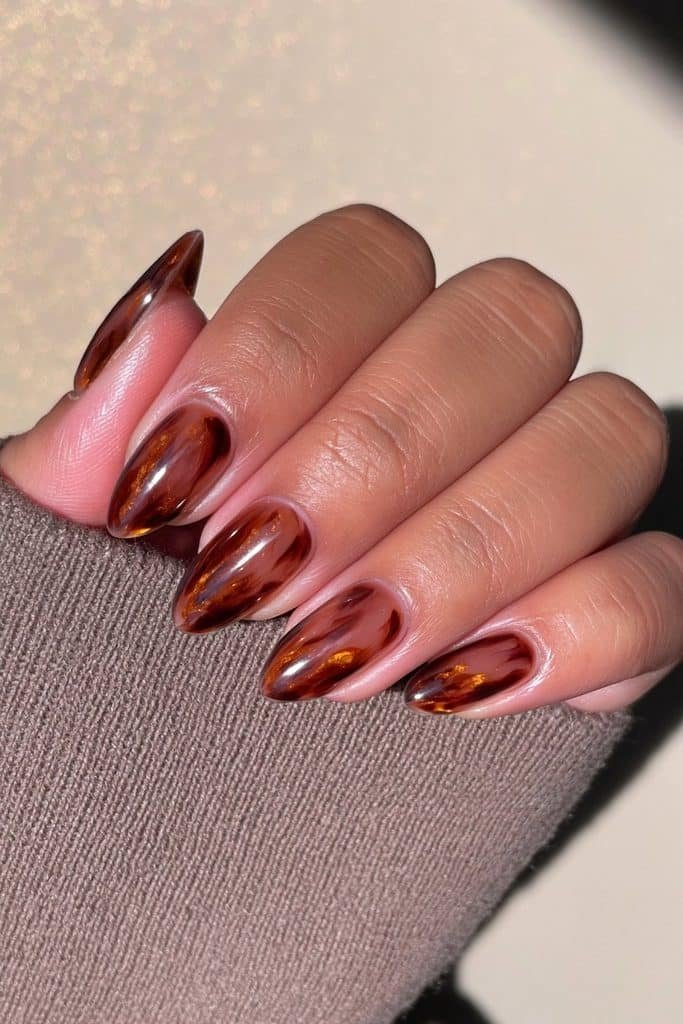 Translucent tortoiseshell jelly nails with amber, caramel, honey, and espresso tones