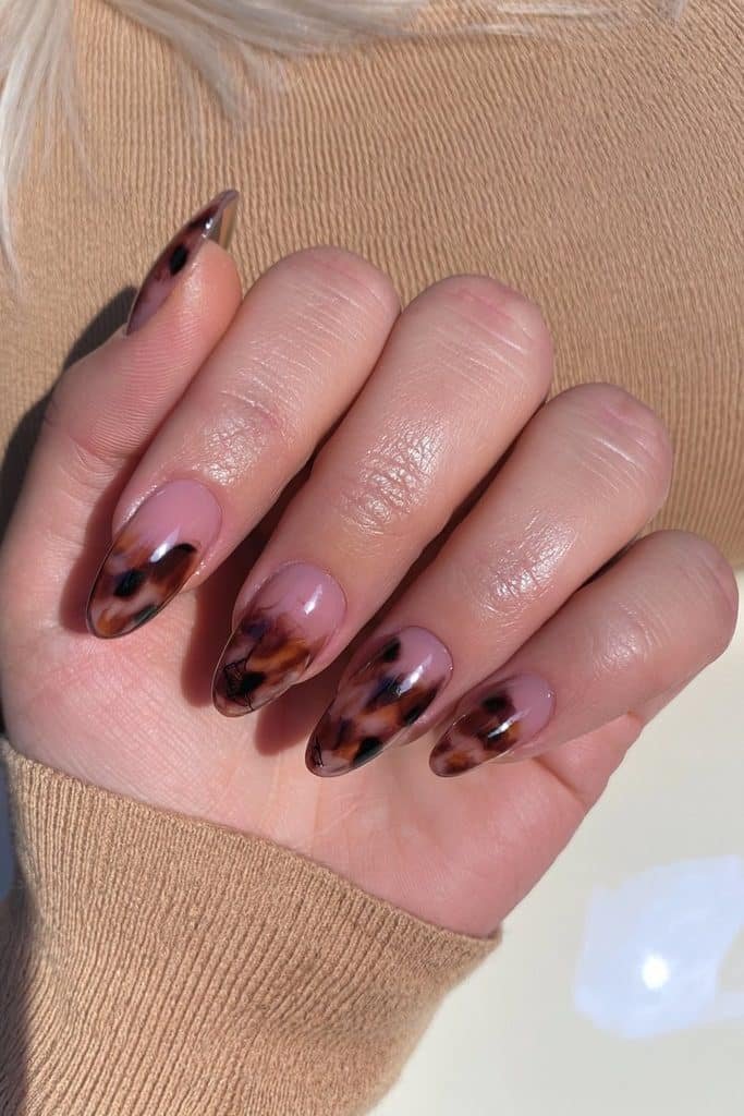 Tortoiseshell spider web nails with translucent amber, caramel, espresso, and black patterns