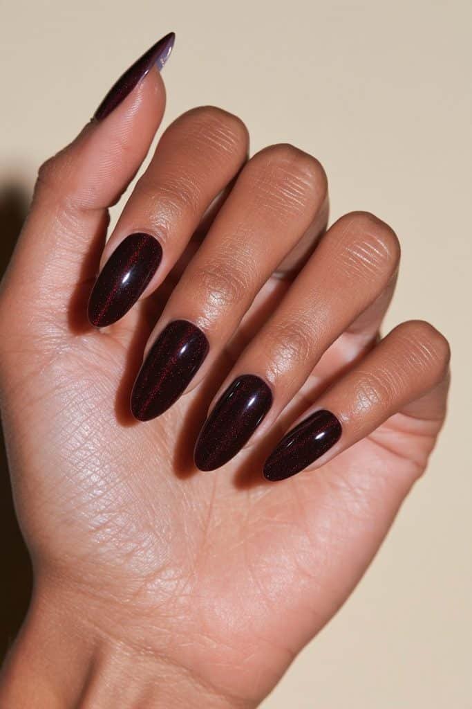 Maroon cat eye nails with ultra-fine magnetic shimmer, delicate ruby highlights, and a smooth glossy top coat.