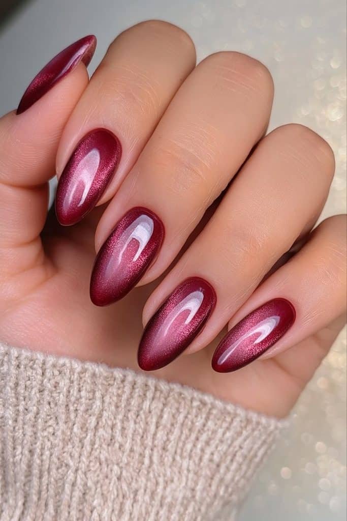 Deep burgundy velvet nails with luminous magnetic wine-red reflections