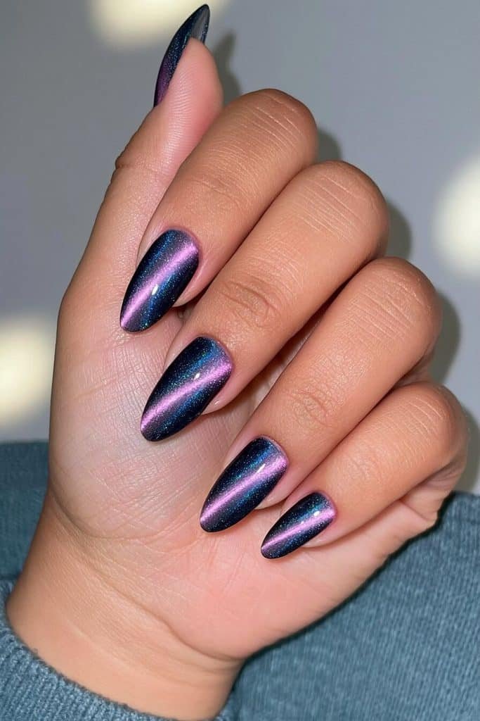 Velvet navy almond cat-eye nails with glowing sapphire ribbons and multidimensional shimmer